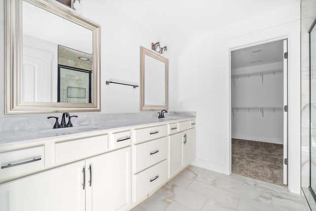 bathroom with vanity and a shower with door