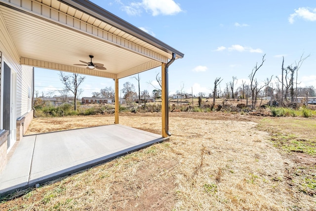 view of yard with ceiling fan and a patio area