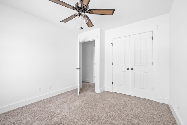 unfurnished bedroom featuring ceiling fan, carpet floors, and a closet