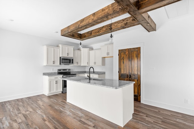 kitchen featuring white cabinets, appliances with stainless steel finishes, a center island with sink, and sink