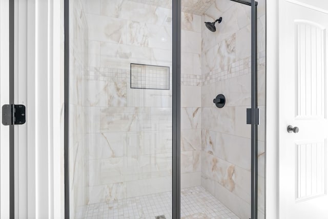 bathroom featuring a shower with door