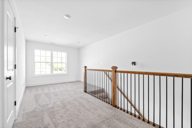 corridor with light colored carpet