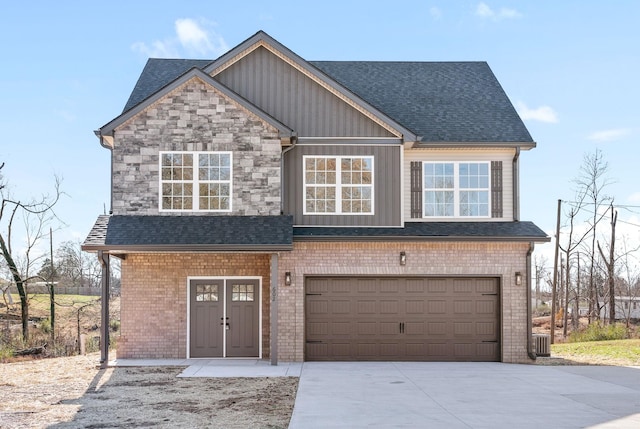 view of front of home featuring a garage and central AC