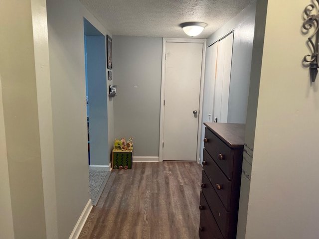 hall featuring hardwood / wood-style floors and a textured ceiling