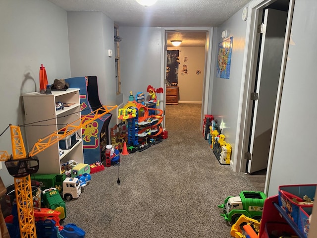 playroom with carpet floors and a textured ceiling