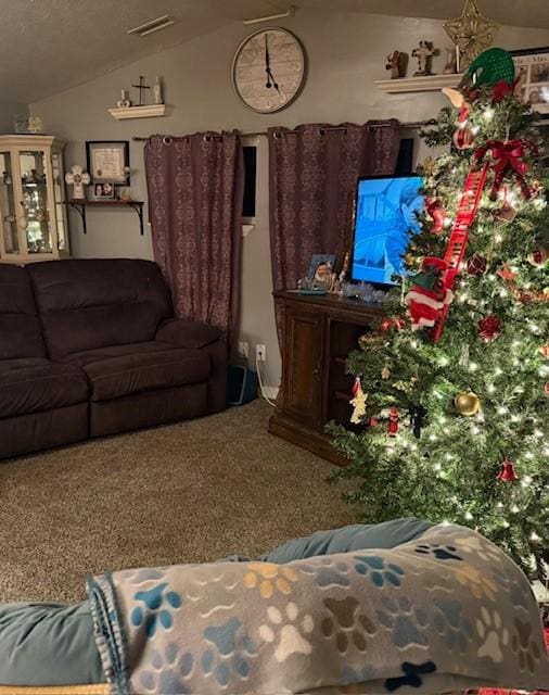 carpeted living room with vaulted ceiling and visible vents