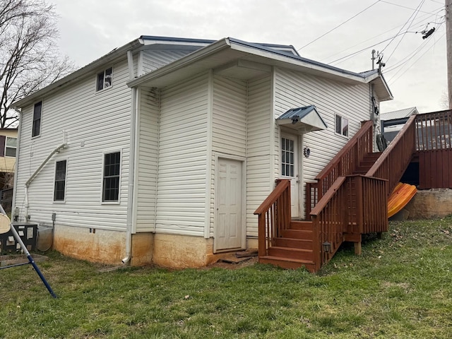 back of property featuring crawl space, central air condition unit, and a yard