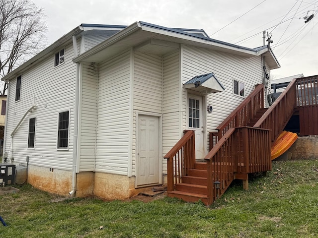 rear view of house with crawl space, cooling unit, and a yard