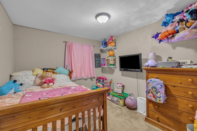 carpeted bedroom featuring a textured ceiling