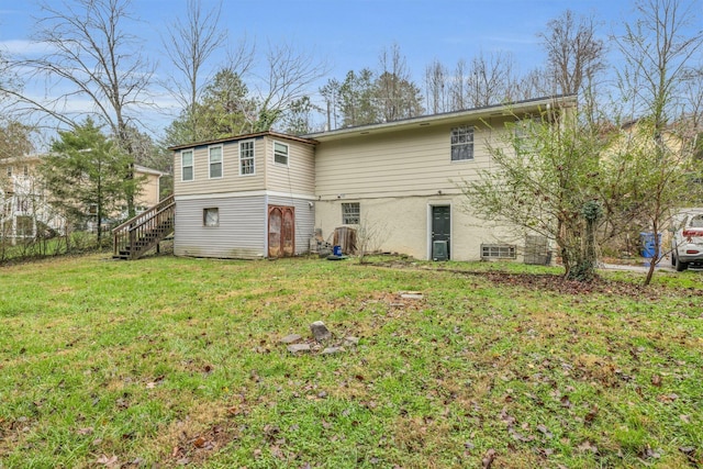 rear view of property featuring a yard