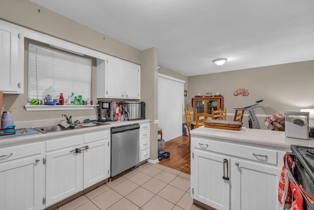 kitchen with white cabinets, appliances with stainless steel finishes, light hardwood / wood-style floors, and sink