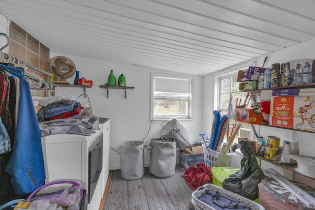 clothes washing area with separate washer and dryer and hardwood / wood-style flooring