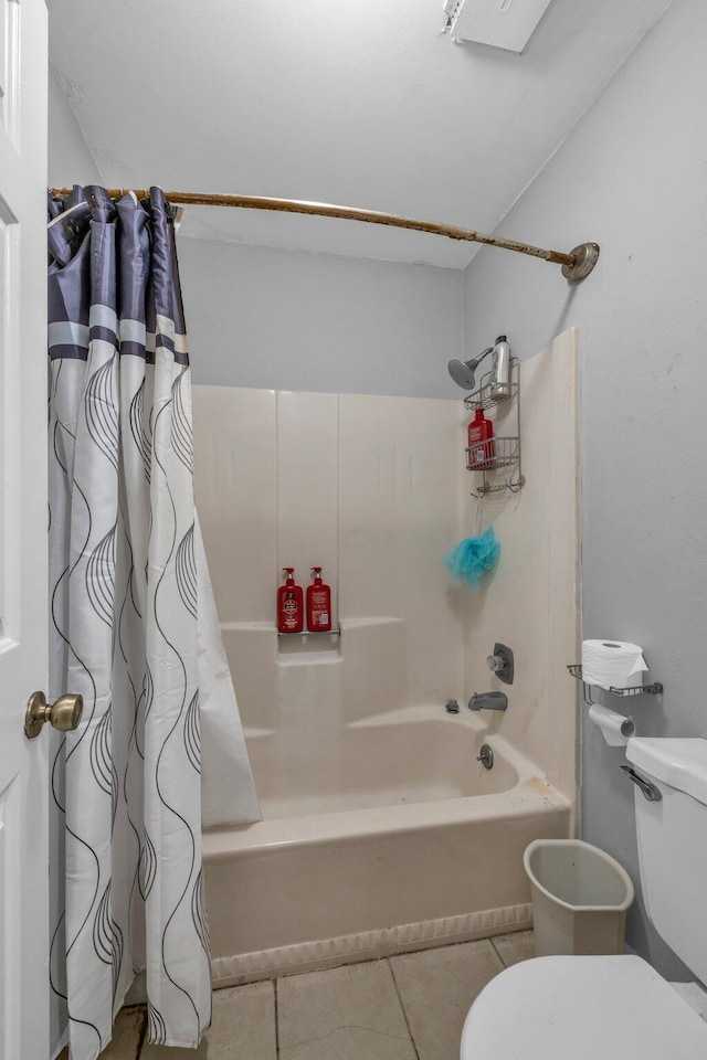 bathroom with tile patterned floors, shower / bathtub combination with curtain, and toilet