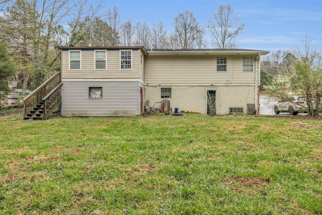 back of property featuring a yard