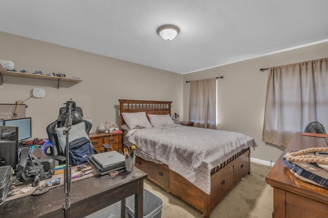 bedroom featuring light carpet and a textured ceiling