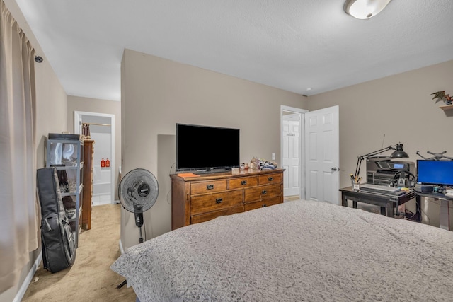 bedroom with light carpet and a textured ceiling