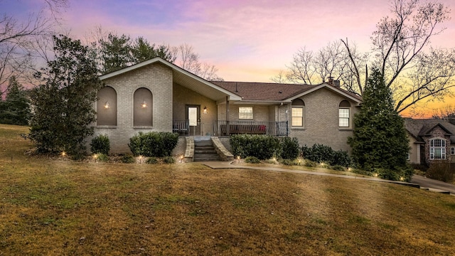 view of front of home with a lawn and covered porch