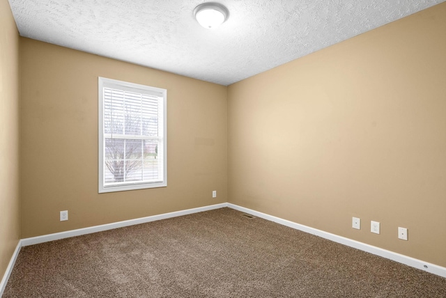 unfurnished room featuring carpet flooring and a textured ceiling