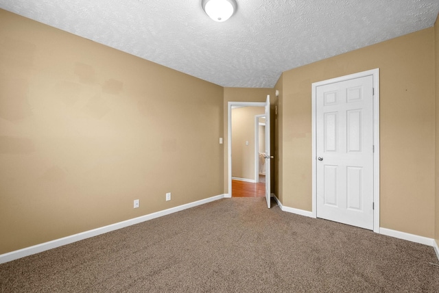 unfurnished bedroom featuring carpet floors and a textured ceiling