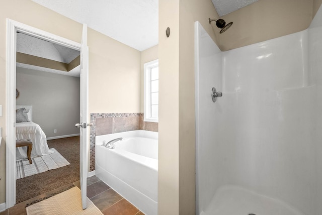 bathroom featuring tile patterned floors, a textured ceiling, and separate shower and tub