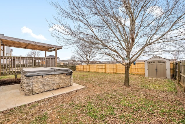 view of yard with a storage shed, a hot tub, and a patio