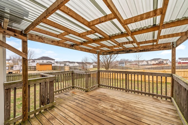 wooden terrace featuring a lawn