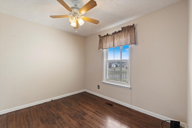 unfurnished room featuring ceiling fan and dark hardwood / wood-style floors