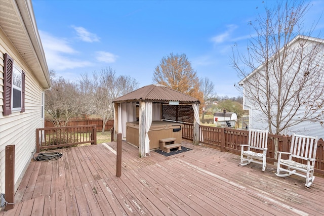 deck with a gazebo and a hot tub