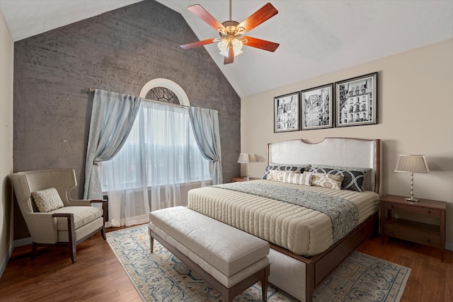 bedroom with ceiling fan, high vaulted ceiling, and hardwood / wood-style floors