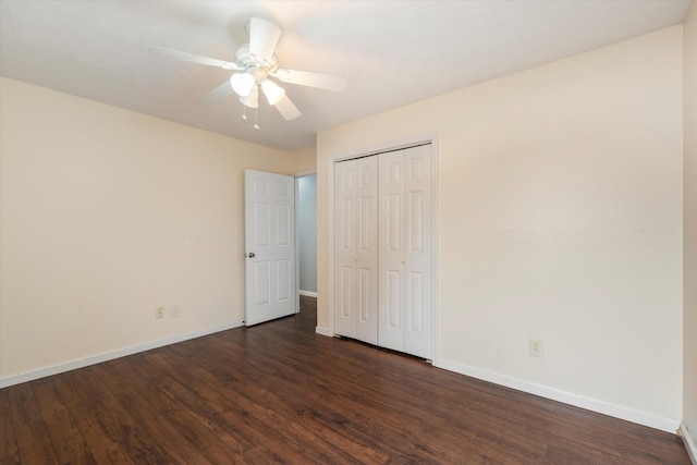 unfurnished bedroom featuring dark wood-type flooring, a closet, and ceiling fan