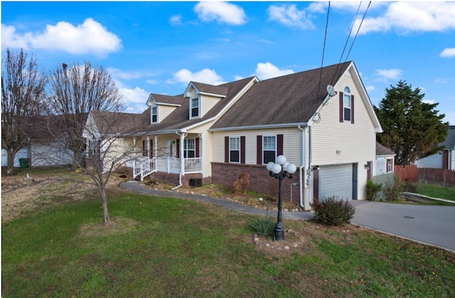 view of front facade featuring a porch, a garage, and a front lawn