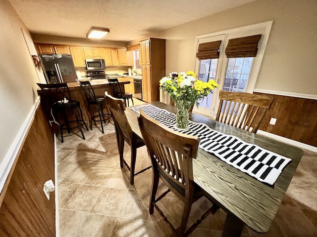 dining area featuring wood walls