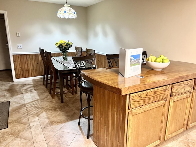 kitchen with wood walls and decorative light fixtures