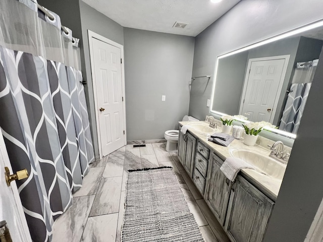 bathroom featuring vanity and toilet