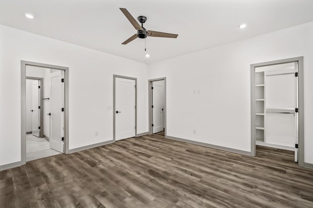 unfurnished bedroom featuring ceiling fan and dark hardwood / wood-style flooring