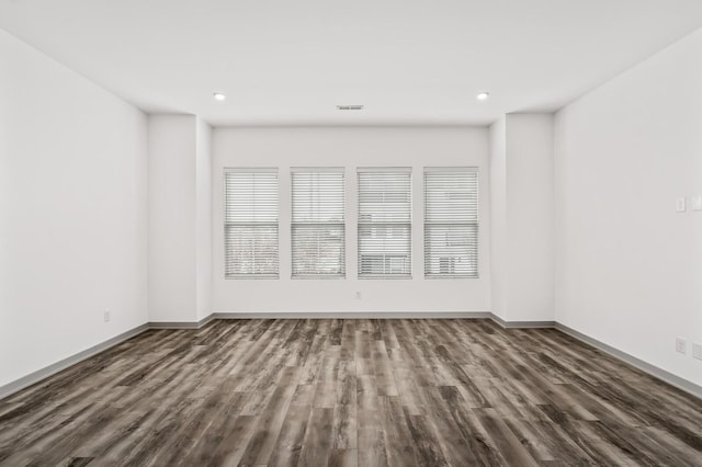 spare room featuring dark wood-type flooring