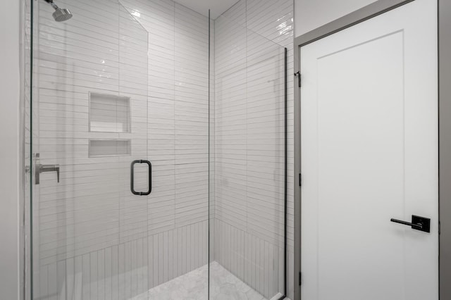 bathroom featuring a shower with shower door