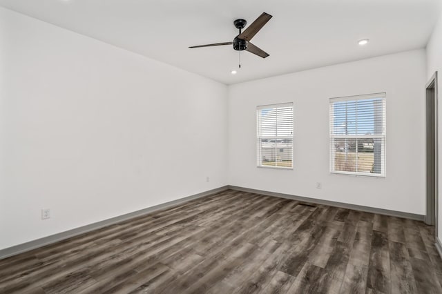 unfurnished room featuring dark hardwood / wood-style floors and ceiling fan