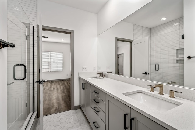 bathroom featuring hardwood / wood-style floors, vanity, and an enclosed shower