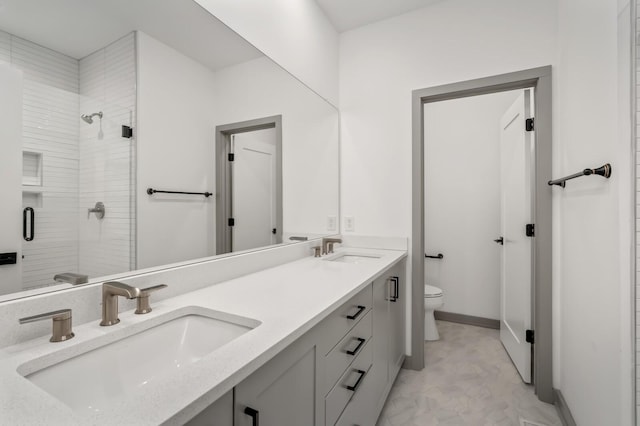 bathroom with an enclosed shower, vanity, and toilet