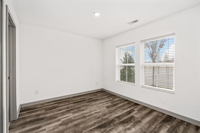 spare room with dark wood-type flooring