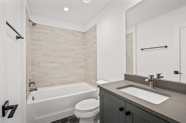 full bathroom with vanity, toilet, and tiled shower / bath combo