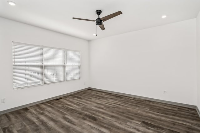 spare room featuring ceiling fan and dark wood-type flooring