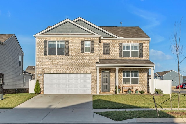 craftsman inspired home featuring a garage and a front lawn