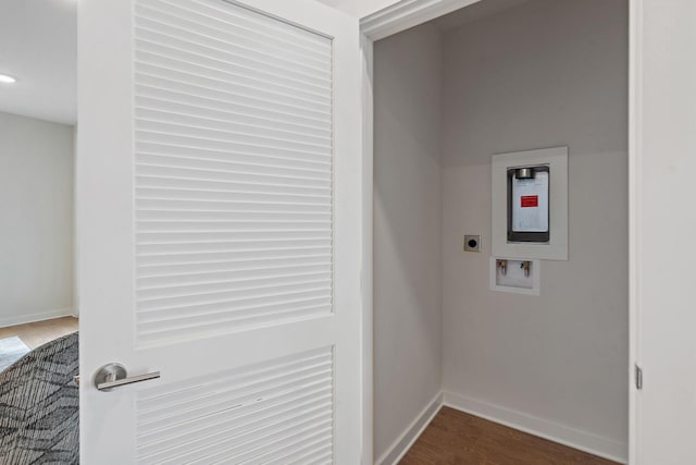 washroom with hookup for an electric dryer, hookup for a washing machine, and dark wood-type flooring