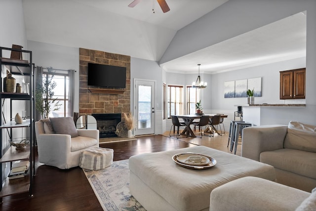 living room featuring light wood-type flooring, vaulted ceiling, and plenty of natural light