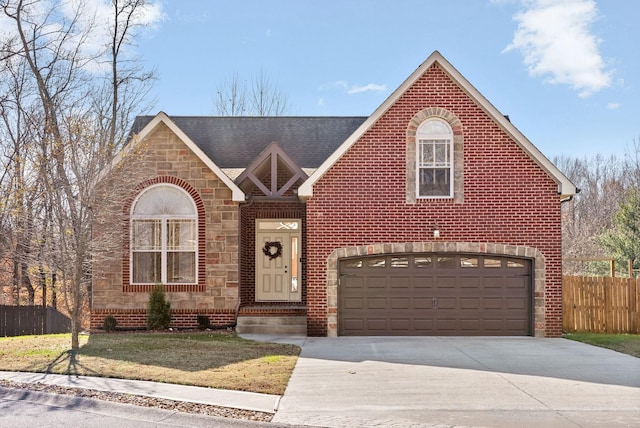 view of property with a garage and a front yard