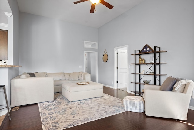 living room with dark hardwood / wood-style floors, high vaulted ceiling, and ceiling fan