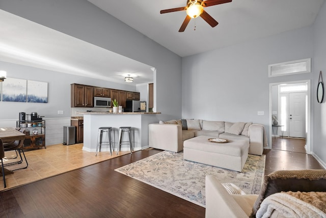 living room featuring ceiling fan and light wood-type flooring