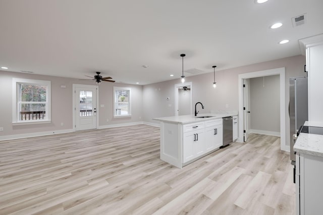 kitchen featuring light wood-type flooring, stainless steel appliances, ceiling fan, white cabinets, and hanging light fixtures